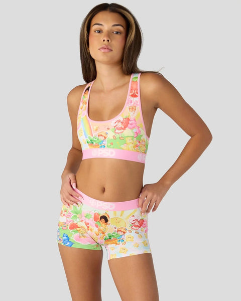 Strawberry Shortcake and Care Bears printed sports bra and shorts set with pink trim and colorful character graphics.