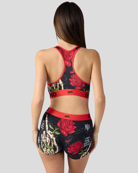 Sports bra and shorts set with red trim and black fabric featuring red roses and skull graphics.