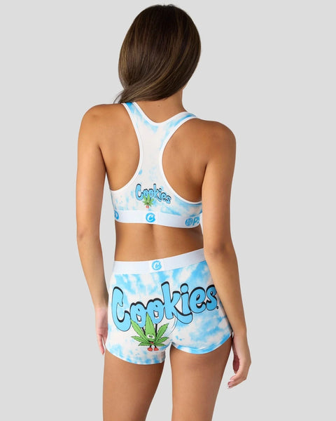 Woman wearing blue and white tie-dye sports bra and shorts set with 