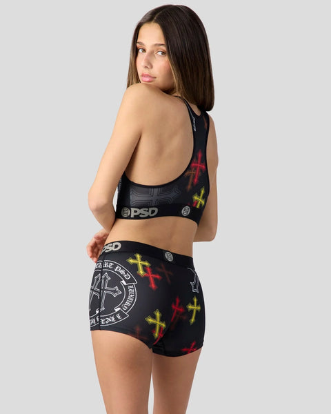 Black sports bra and shorts set with red and yellow cross patterns and PSD branding.