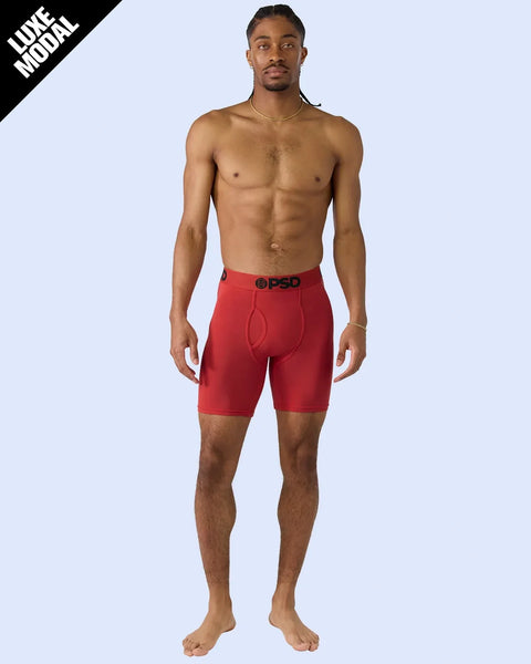 Man wearing red PSD boxer briefs with black waistband.