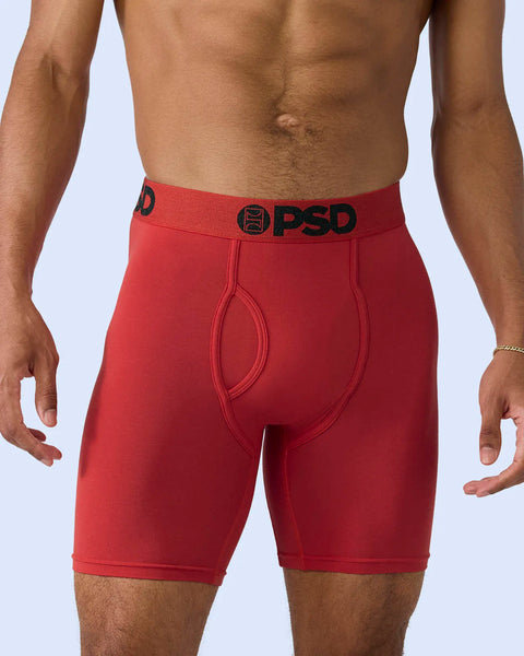 Red modal boxer brief with black PSD waistband logo, shown on male model against white background.