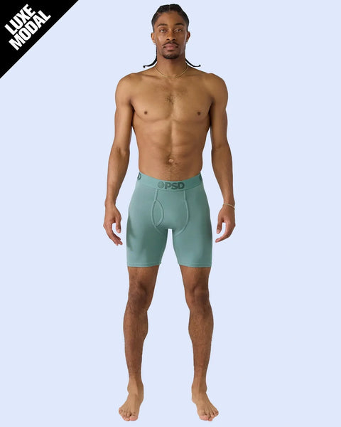 Man wearing jade green modal boxer briefs with branded waistband and contrast stitching.