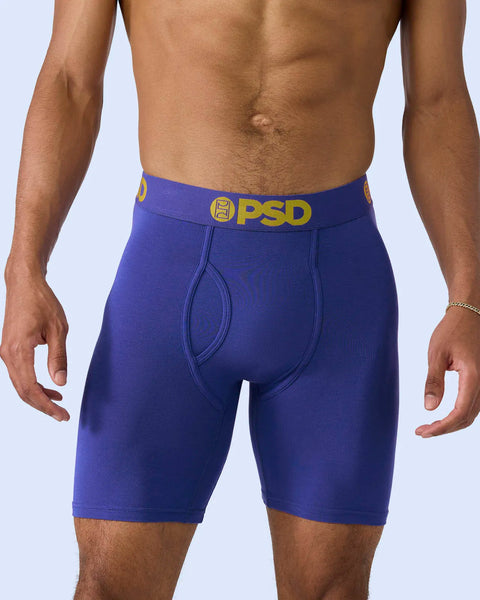 Royal blue boxer briefs with gold PSD waistband and front pouch detail.