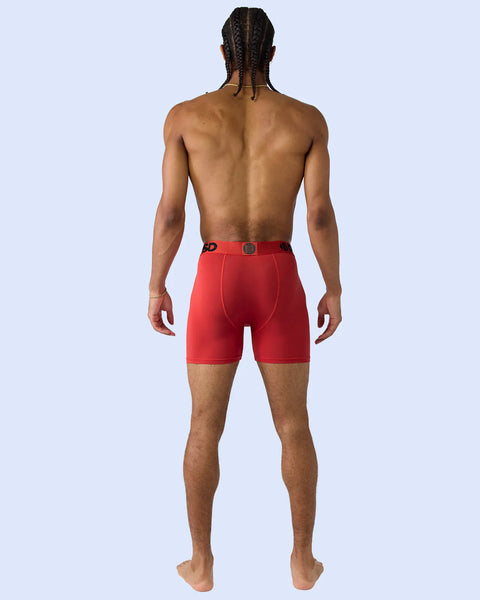Red modal boxer shorts with button closure, shown on male model from back view.