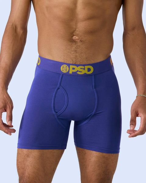 Royal blue boxer briefs with yellow PSD waistband and logo on model.