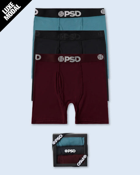 Three modal boxer briefs in teal, black, and burgundy with PSD waistbands, shown stacked and in packaging.
