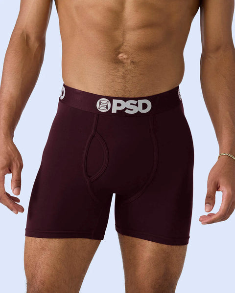 Man wearing dark burgundy boxer briefs with white PSD waistband and logo.