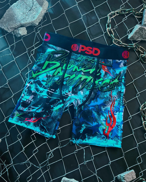 PSD brand underwear with blue, green, and red graphic print design on dark mesh background.