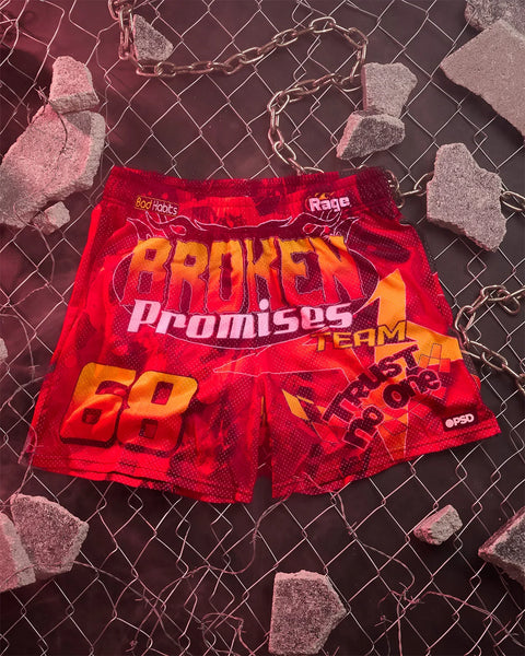 Red active shorts with "Broken Promises" text and orange graphic design on front.
