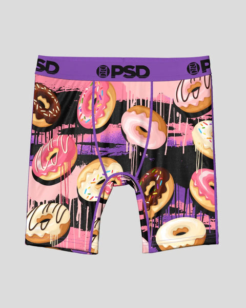 Men's boxer briefs with purple PSD waistband featuring colorful illustrated donuts and dripping glaze on pink and black backg