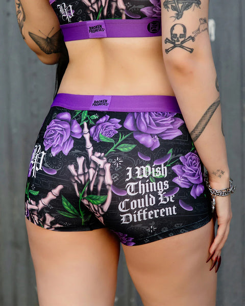 Black shorts with purple roses, skeletal hands, and 