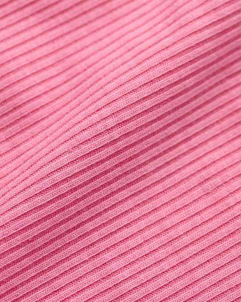 Baby pink ribbed knit fabric with vertical texture lines.