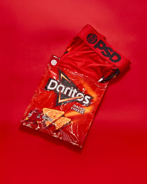 Doritos Nacho Cheese bag with red packaging and triangular chip visible on red background.