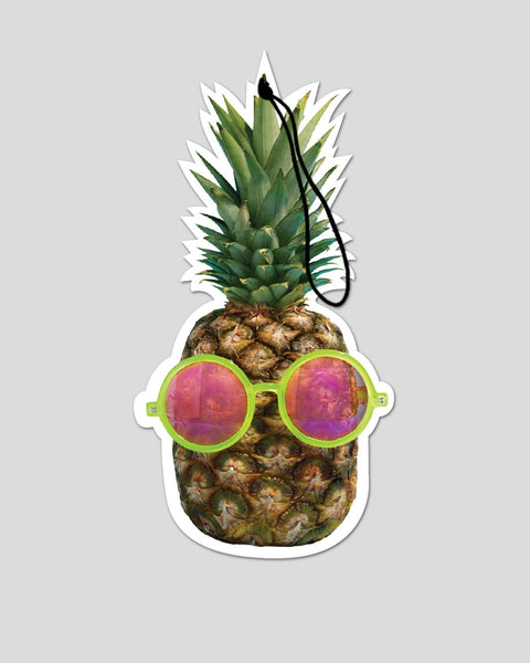 Pineapple-shaped air freshener with lime green frame sunglasses and pink reflective lenses.