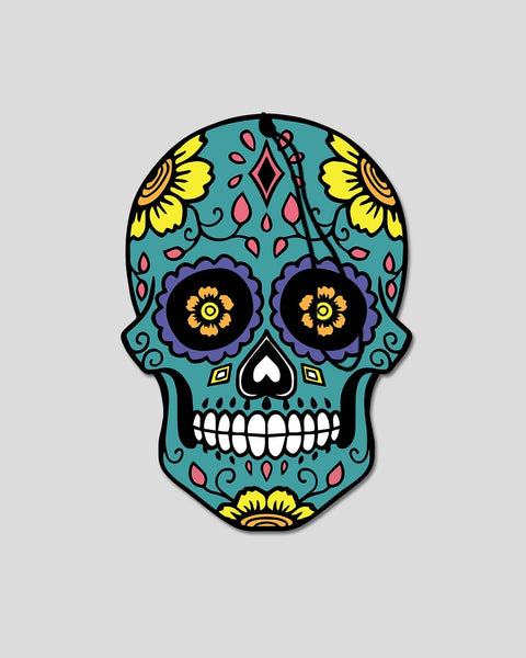 Teal candy skull with yellow flowers, purple eye sockets, pink details, and white teeth on black outline.