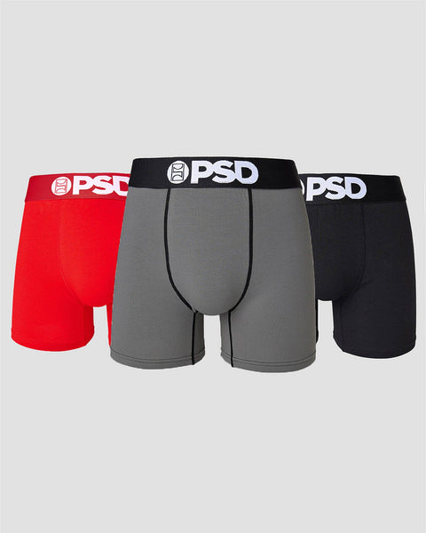 Three PSD boxer briefs in red, grey, and black with white waistband logos displayed side by side.
