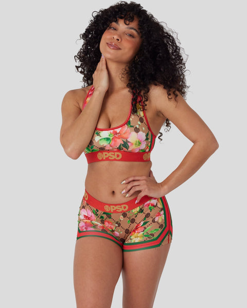 Women's two-piece swim set with multicolored floral print, red trim, and PSD branding on elastic bands.