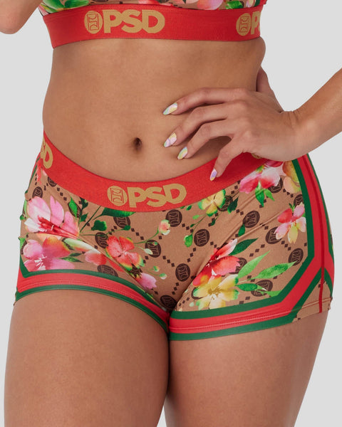 Red and tan briefs with multicolor floral print, red waistband with PSD branding, and green trim accents.