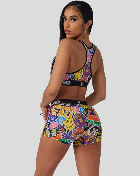 Playboy Peace Love sports bra and shorts set with multicolored peace symbol and text print on black background.