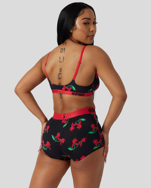 Black bralette and boyshort set with red cherry print and pink trim bands.