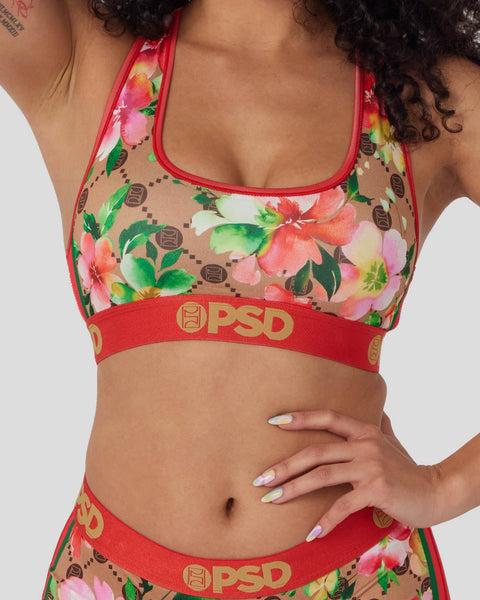 Sports bra and briefs set with pink and yellow floral print on tan base, red trim and PSD branding.