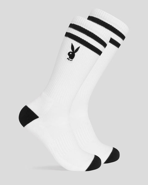 White crew socks with black stripes at cuff and black heel and toe accents featuring Playboy bunny logo.