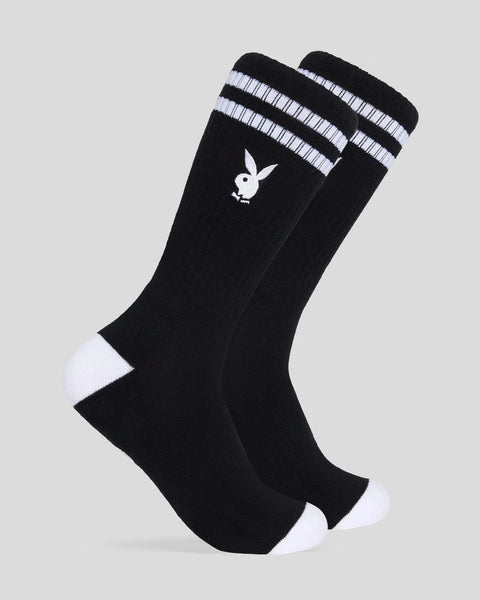 Black crew socks with white Playboy bunny logo, white striped cuffs, and white toe and heel accents.