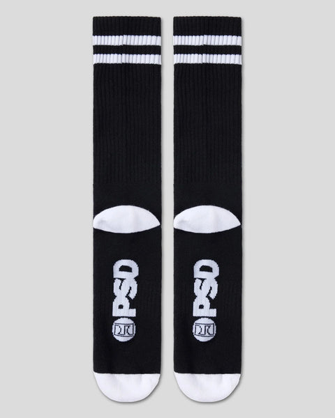 Two black crew socks with white stripes at cuff, white toe and heel, and Playboy bunny logo design.