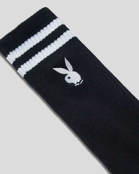 Black crew sock with white horizontal stripes at cuff and white embroidered Playboy bunny logo.