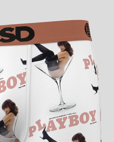 White underwear with tan waistband featuring Playboy branding, martini glass graphic, and model imagery.
