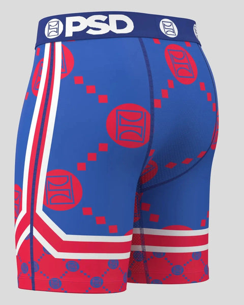 Blue and red PSD athletic shorts with Warface emblem pattern, white stripe trim, and branded waistband.