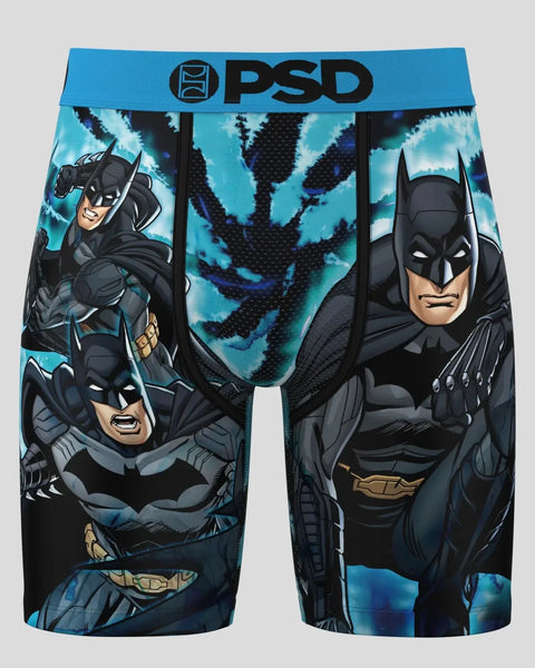 PSD Batman Dye boxer briefs with blue waistband, featuring Batman character illustrations and tie-dye pattern.