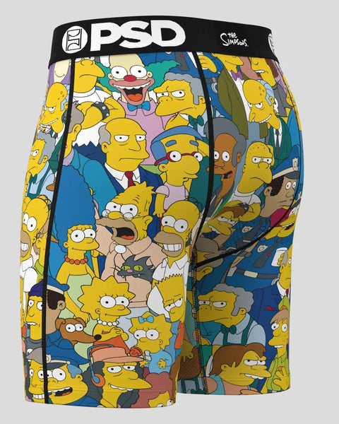 PSD brand boxer shorts with all-over print of The Simpsons characters in yellow, blue, and brown tones.