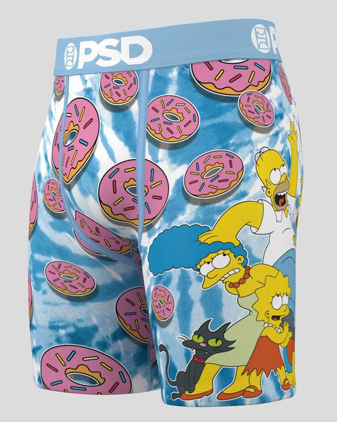 PSD brand blue tie-dye boxer shorts with pink frosted donut print and Simpsons characters Homer, Marge, Bart, Lisa, and cat.