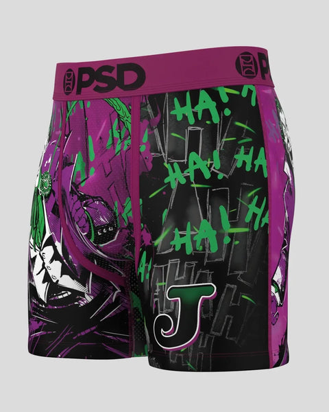 PSD boxer briefs with purple and black colorblock design, green graffiti text, and character artwork on sides.