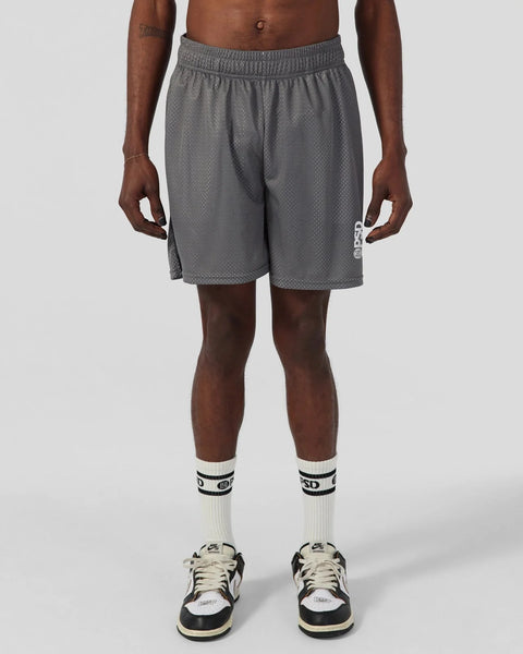 Charcoal mesh athletic shorts with elasticated waistband, shown on model wearing white crew socks and black sneakers.