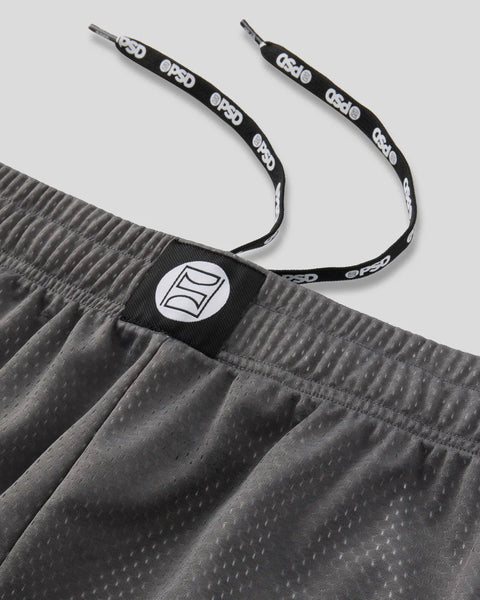 Charcoal shorts with textured fabric, adjustable drawstring with branded loops, and circular logo patch on waistband.