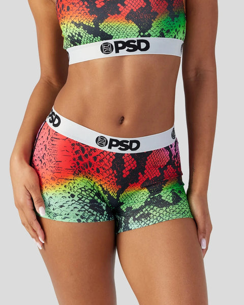 PSD sports bra and shorts set with red, yellow, and green snake-scale pattern and white logo waistbands.