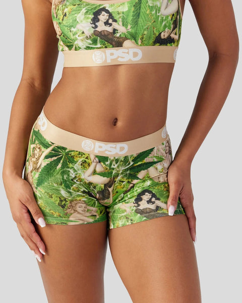 Green vintage-print sports bra and shorts set with beige PSD waistbands and retro female portraits.
