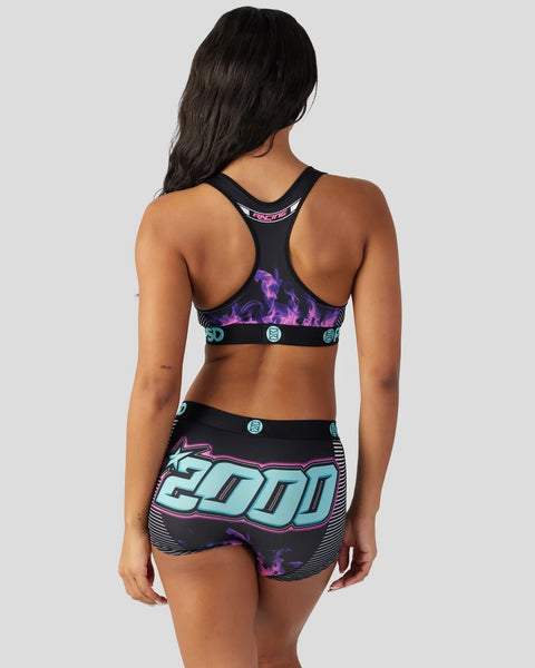 Black sports bra and shorts set with purple flame and cyan geometric graphics, shown on model from back.