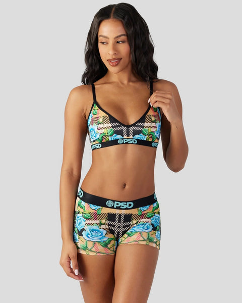 Woman wearing tartan floral patterned bralette and shorts with black trim and PSD branding.