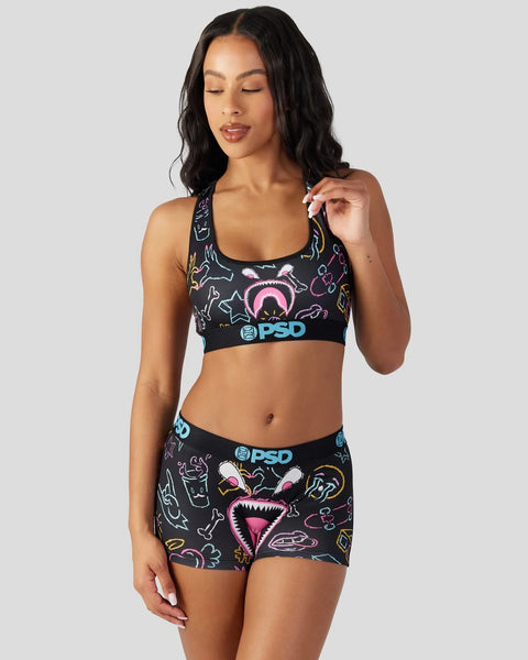 Black sports bra and shorts set with colorful neon graphic print and PSD branding.