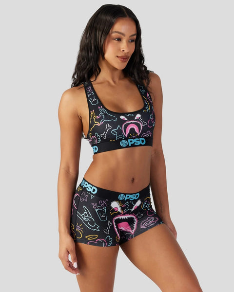 Black sports bra and shorts set with neon colorful monster and creature graphics and blue PSD branding.