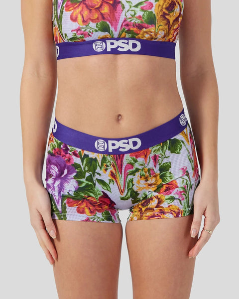 Colorful floral print crop top and matching shorts set with purple PSD waistbands on light background.