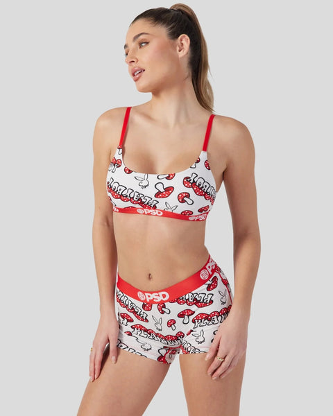 Woman wearing red and white Playboy mushroom print bra and matching shorts with red straps.
