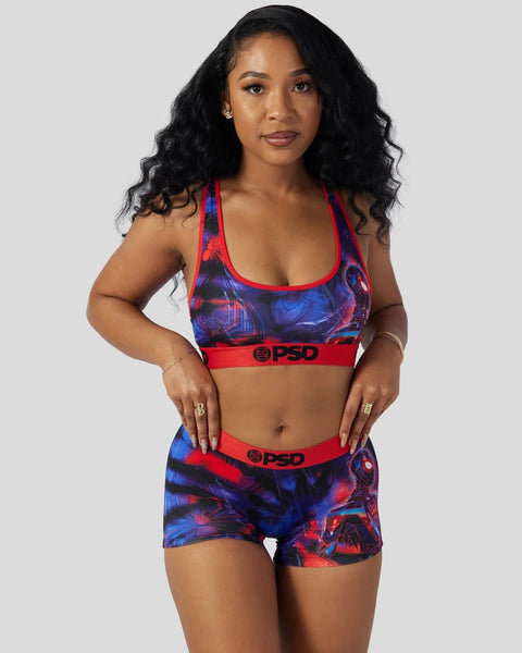 Woman wearing red and blue Miles Morales-themed sports bra and shorts set with geometric print design.