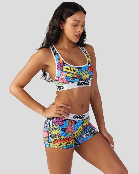 Woman wearing colorful SpongeBob SquarePants print sports bra and shorts set with PSD branding.