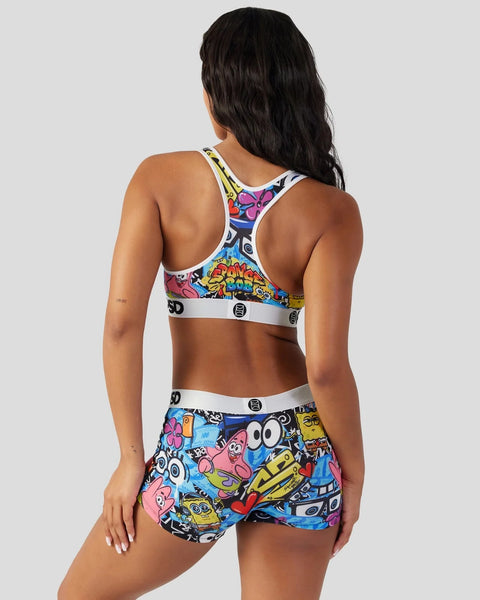 Woman wearing SpongeBob SquarePants colorful character print sports bra and shorts with white elastic waistbands.