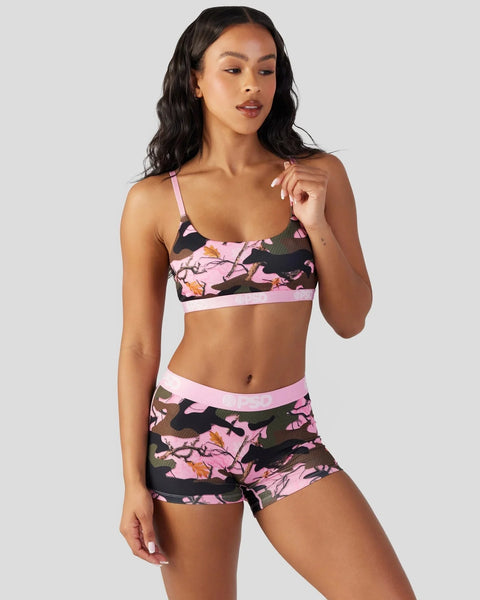 Pink and black camo sports bra and shorts set with adjustable straps and white trim.